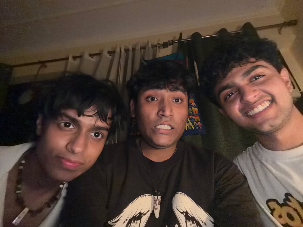 Three friends taking a close selfie indoors